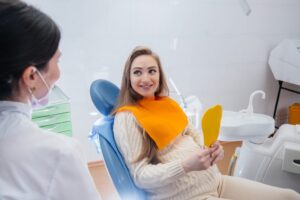 A professional dentist treats and examines the oral cavity of a pregnant girl in a modern dental office. Dentistry.