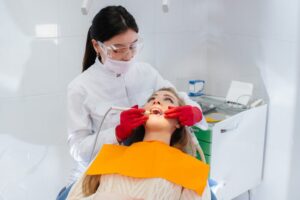A professional dentist performs treatment and examination of the patient's oral cavity in close-up. Dentistry.